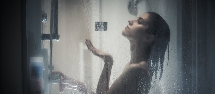 Молодая красивая женщина под душем в ванной комнате