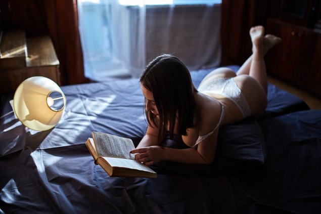 Девушка в постели с книжкой